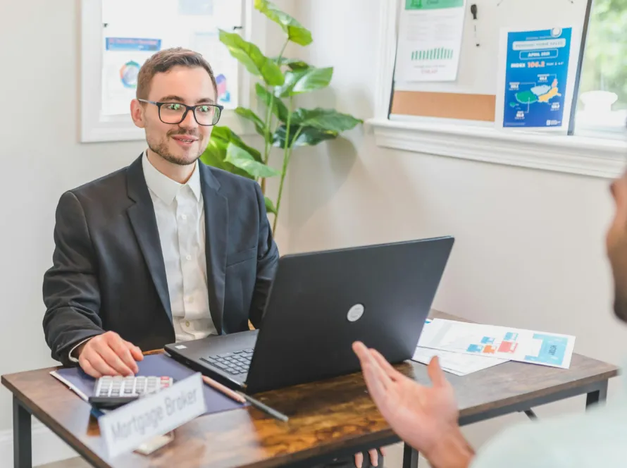 A professional business gas broker in the UK discussing energy solutions with a client at an office desk